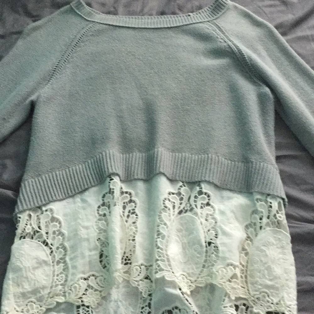 A small grey blouse with white lace sewed as one